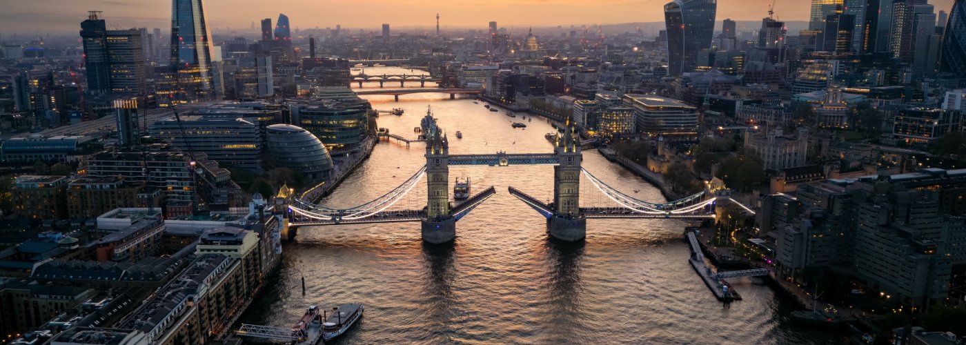Beautiful aerial sunset view of the Tower Bridge and skyline in London along the River Thames, England